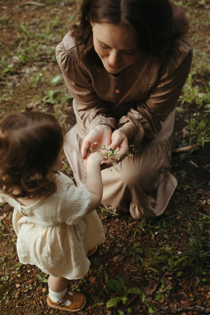 mom and daughter embraces the natural wonders of summer flora and fauna