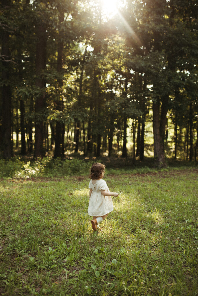 a little girl basking in the golden rays of sumemr