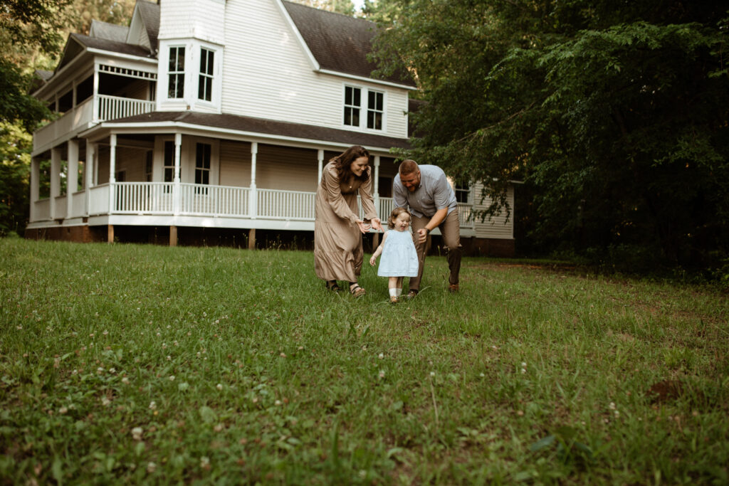 a family plays chase with their daughter full of laughter