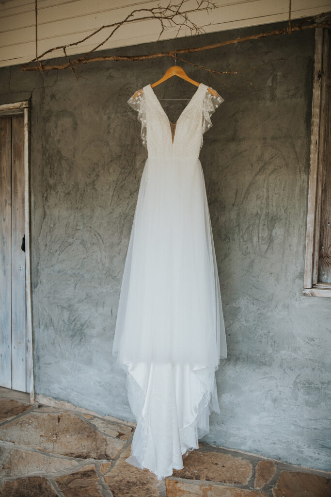 A brides dress hung for a beautiful detail shot