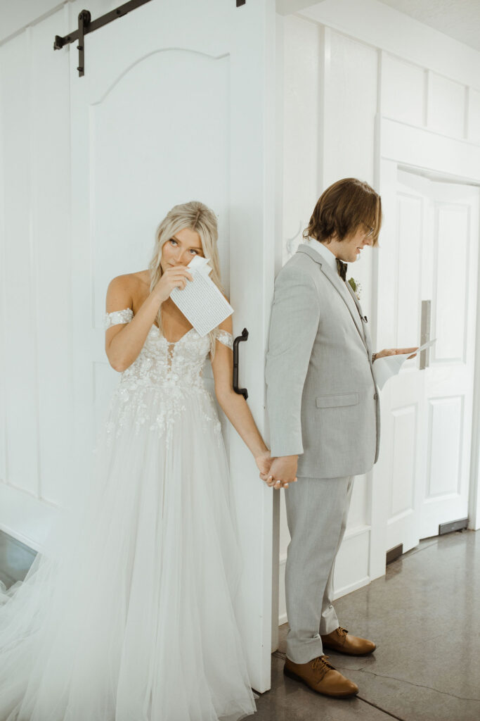 bride and groom reading private vows during a first touch